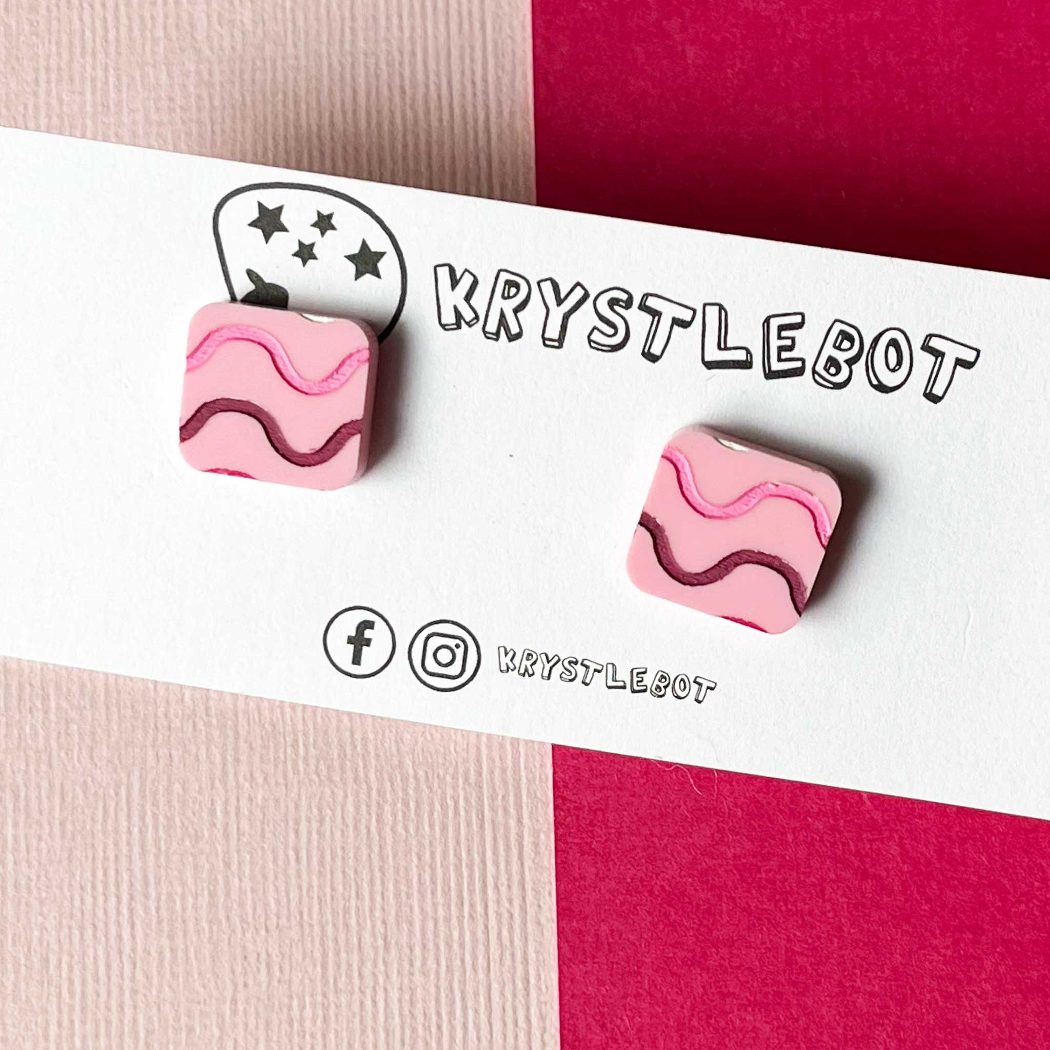 Pink and brown wavy patterned earrings on a brand card with 'KRYSTLEBOT' branding.
